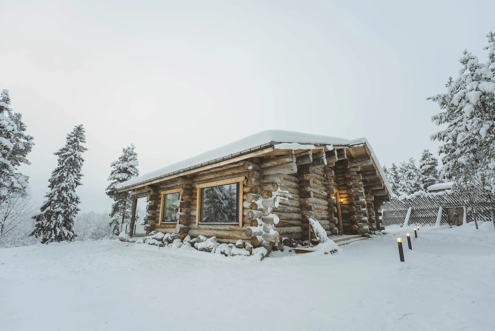 Außenansicht der Luxus-Blockvilla im verschneiten Wald