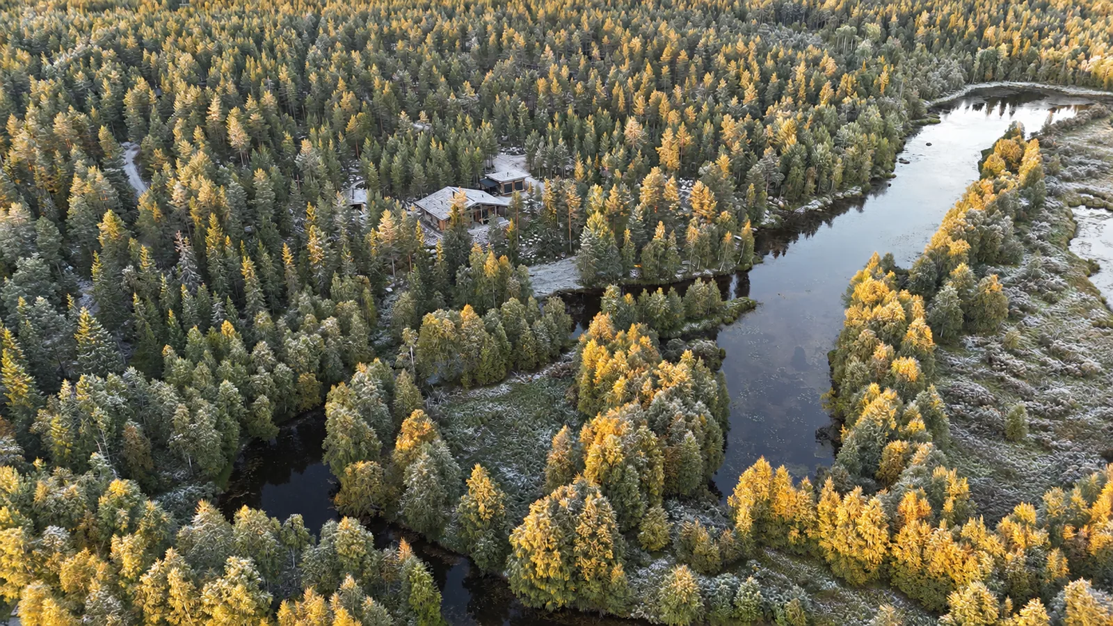 Luxus-Blockvilla im Herbst am Fluss aus der Vogelperspektive